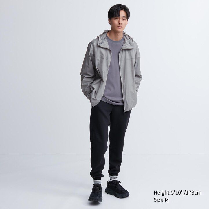 orangefarbene uniqlo herrenjacke mit uv-schutz 3d-schnitt und taschen